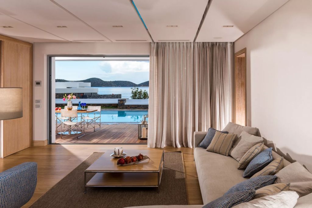 Wohnbereich mit Zugang zur Terrasse und privatem Pool im Elounda Beach Hotel