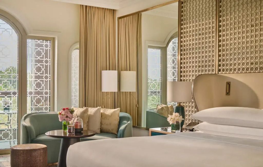 Sitzbereich im Deluxe Zimmer mit Tisch und Sofaecke neben dem Fenster