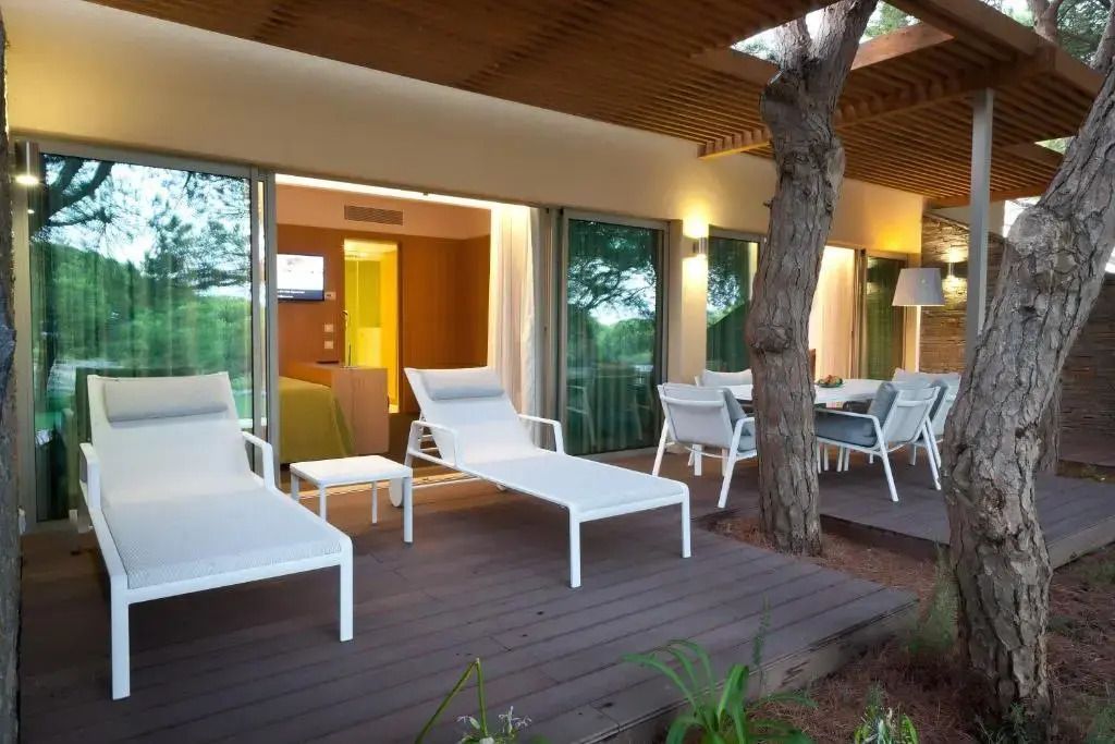 Terrasse mit Liegestühlen und Sitzbereich mit Gartenblick in Deluxe Suite