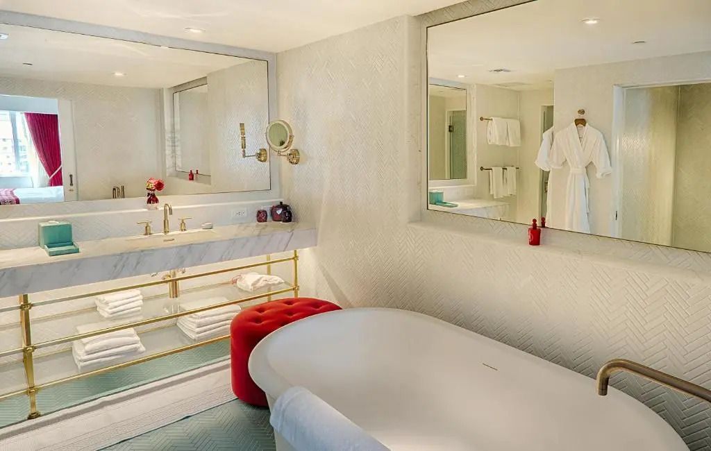 Luxuriöses Badezimmer mit freistehender Badewanne, Marmorwaschbecken und stilvollem Interieur.