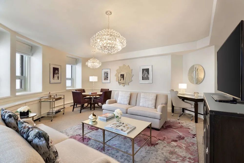Heller Wohnbereich der Céline Dion Suite mit eleganten Sofas und Kristallleuchtern