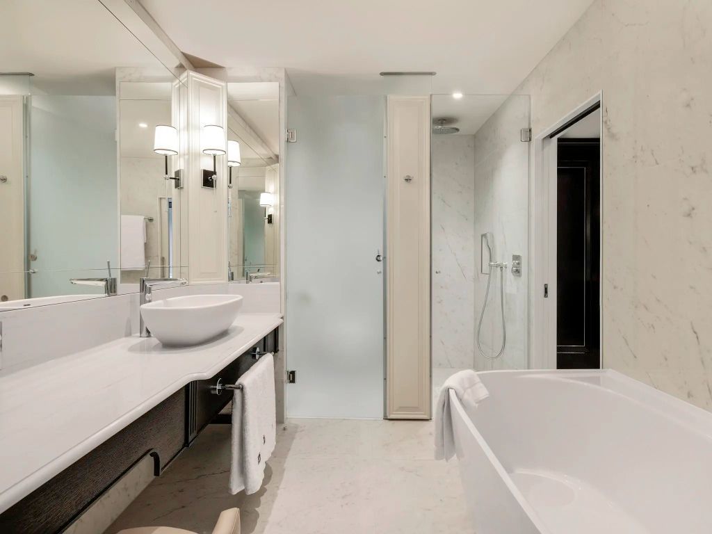 Modernes Badezimmer mit freistehender Badewanne und großem Spiegel im Fairmont Hotel Windsor Park.