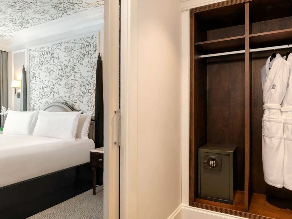 Einblick in die Suite mit offener Kleiderablage und gemütlichem Doppelbett