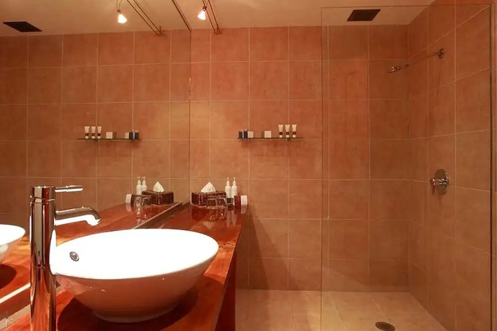 Modernes Badezimmer mit Waschbecken und großer Dusche im Hotel Fiordland Lodge