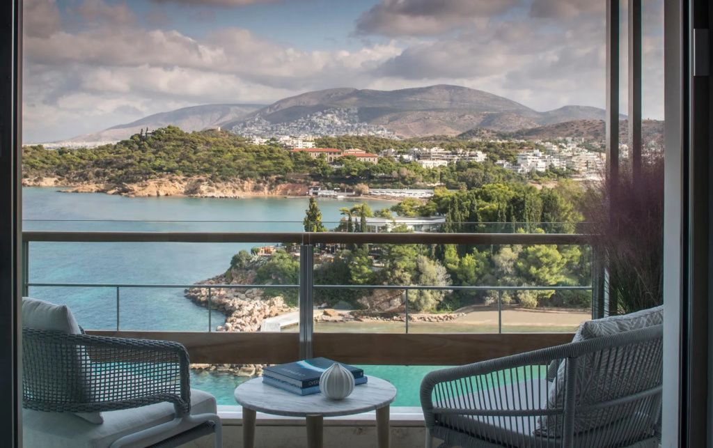 Privater Balkon mit gemütlichen Sesseln und traumhaftem Blick auf Bucht und Berge.