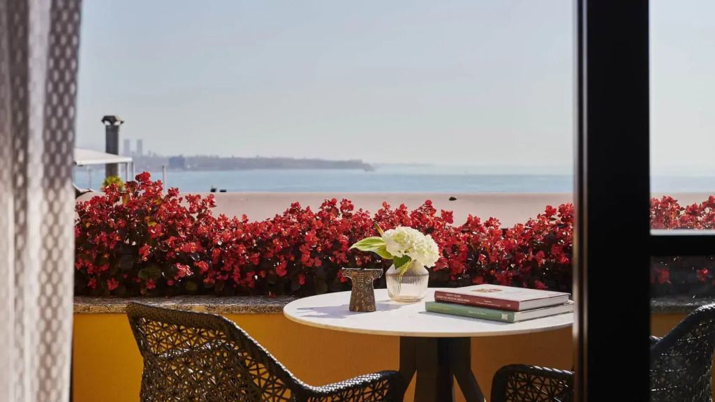 Balkon mit Tisch und Blumen mit Blick auf das Meer