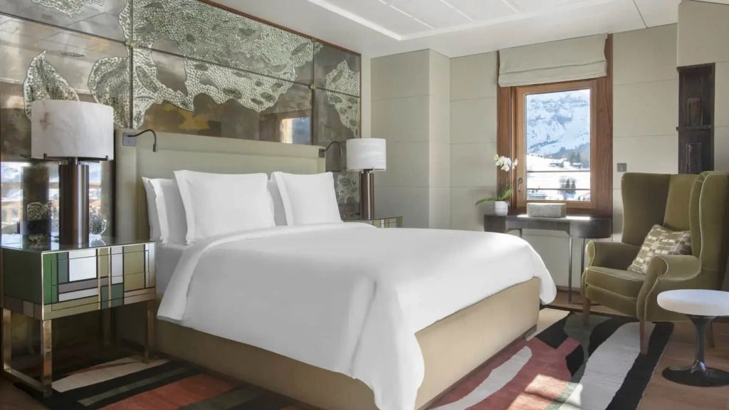 Luxuriöses Schlafzimmer mit großem Bett und Blick auf die Berge im Four Seasons Hotel Megeve.