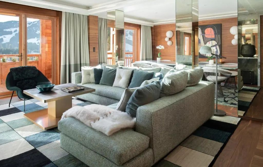 Große Lounge mit bequemen Sofas, Kissen und Panoramafenstern.