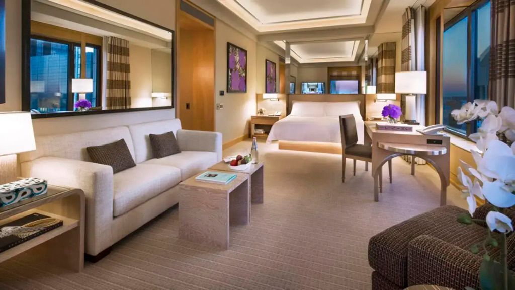 Luxuriöses Zimmer mit großem Bett, Sofa und elegantem Tisch