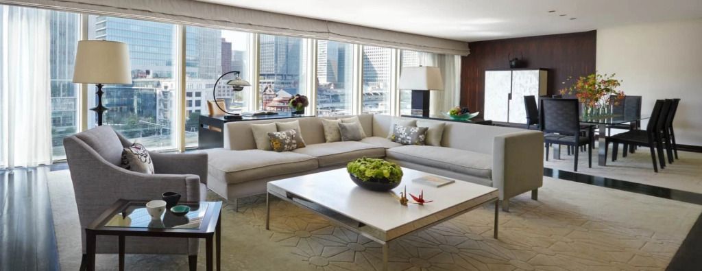 Moderner Wohnbereich mit großem Sofa und Fensterblick auf die Stadt