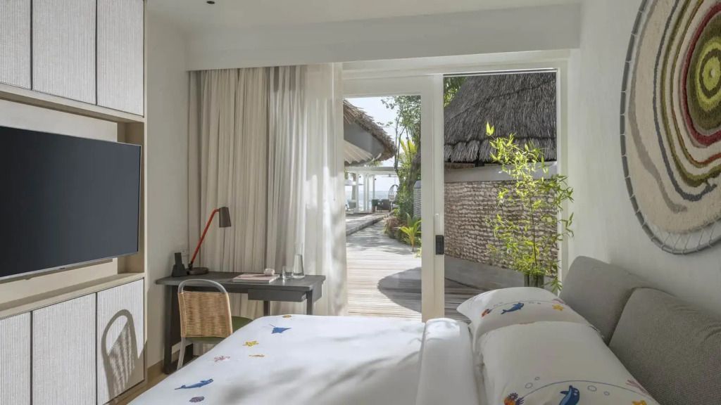 Schlafzimmer mit Schreibtisch und direktem Zugang zur Terrasse