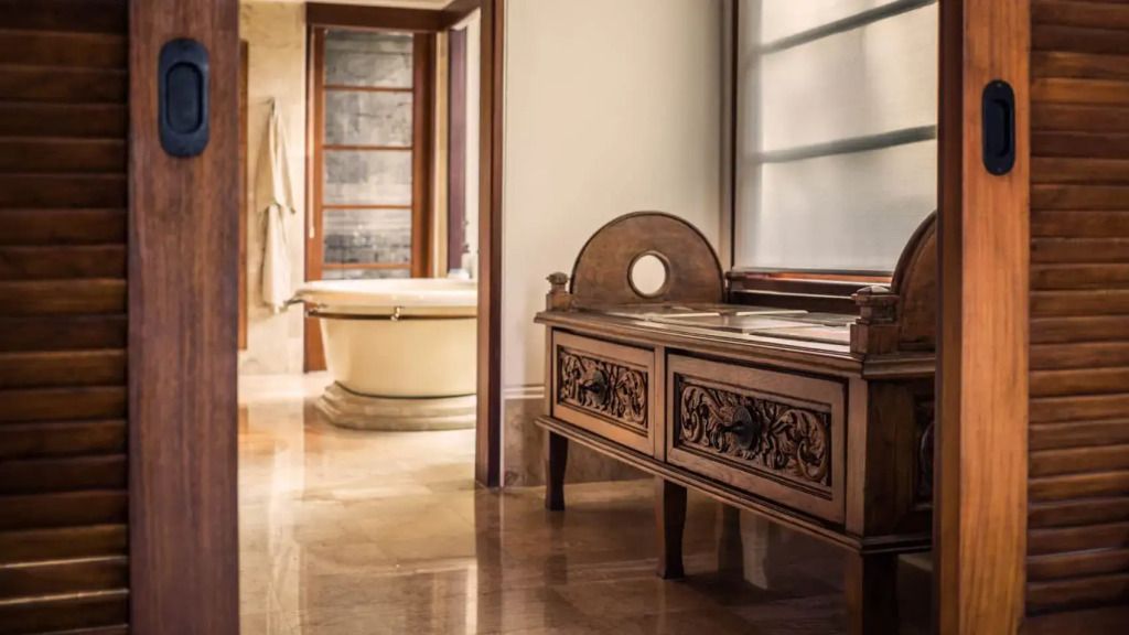 Elegantes Bad mit Holzbank und Badewanne im Resort