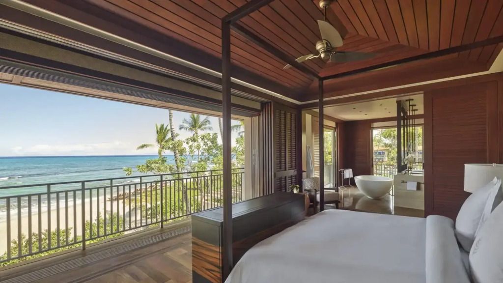Schlafzimmer mit Balkon und Blick auf Palmen und Meer