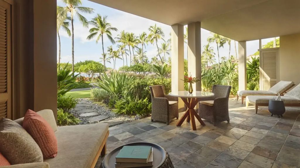 Privat-Terrasse mit Sitzgelegenheit und Blick auf tropischen Garten