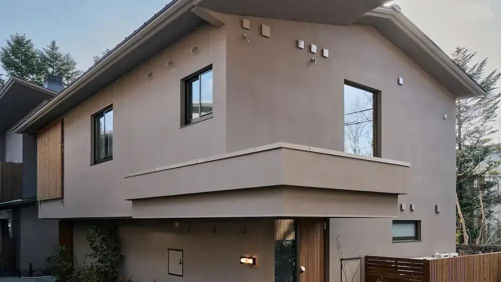 Außenansicht der modernen Villa mit großen Fenstern und klaren Linien.
