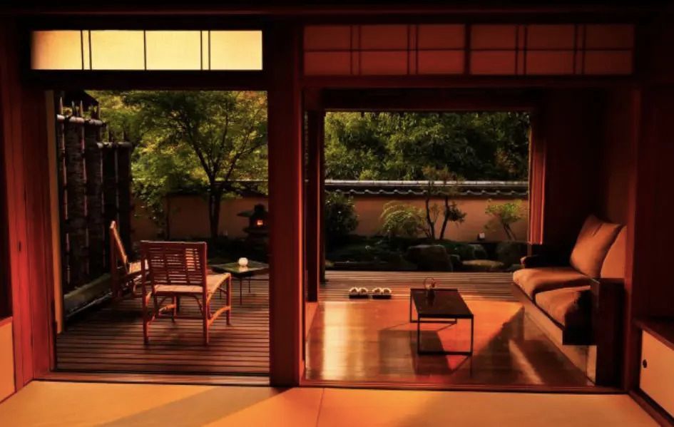 Offenes Wohnzimmer mit Blick auf den Garten und japanischem Dekor.
