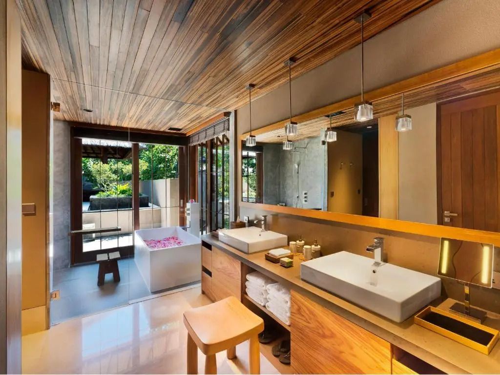 Luxuriöses Badezimmer mit Holzdecke und freistehender Badewanne