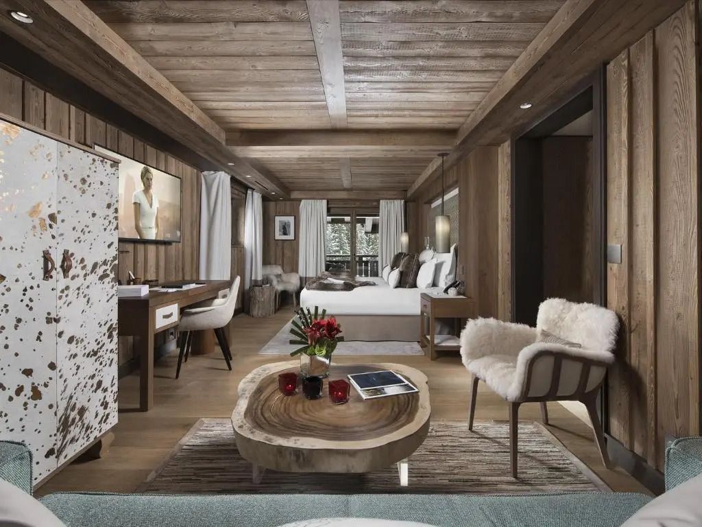 Langer Raum der Prestige Junior-Suite mit Sitzbereich und rustikalen Holzwänden.