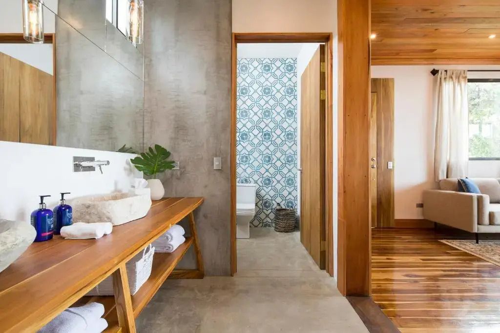Modernes Badezimmer mit Holz-Akzenten und blauer Fliesenwand