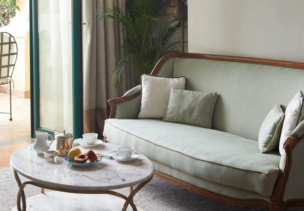 Elegantes Wohnzimmer mit klassischem Sofa und Marmortisch im Hotel Caruso