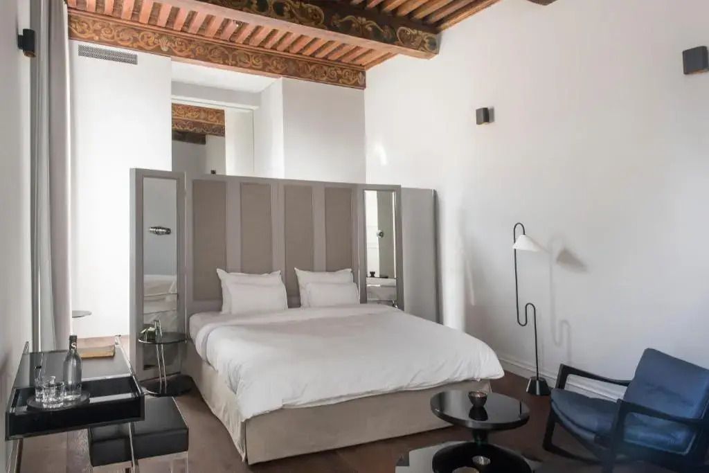 Elegantes Schlafzimmer mit Himmelbett und kunstvollen Deckenbalken