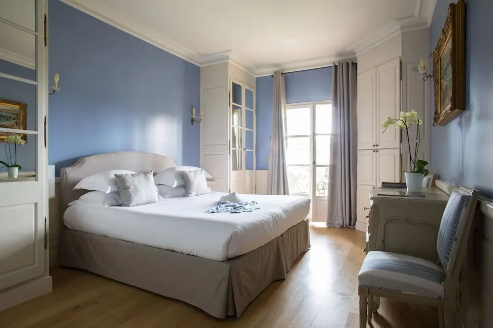 Helles Zimmer mit blauer Wandfarbe und stilvollem Interieur im Hôtel et Spa du Castellet