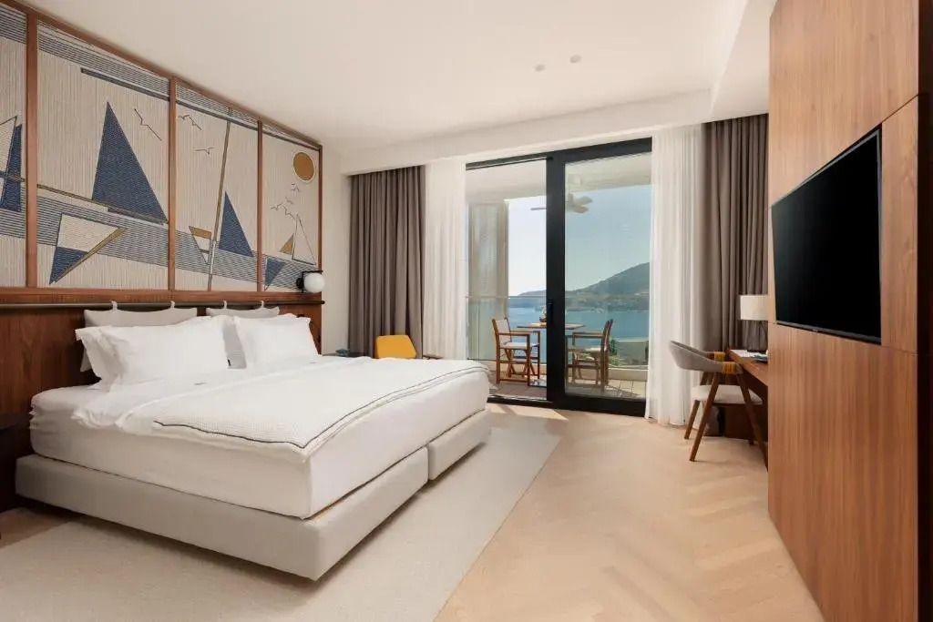 Luxuriöses Deluxe Zimmer mit großem Bett und Balkon mit Meerblick