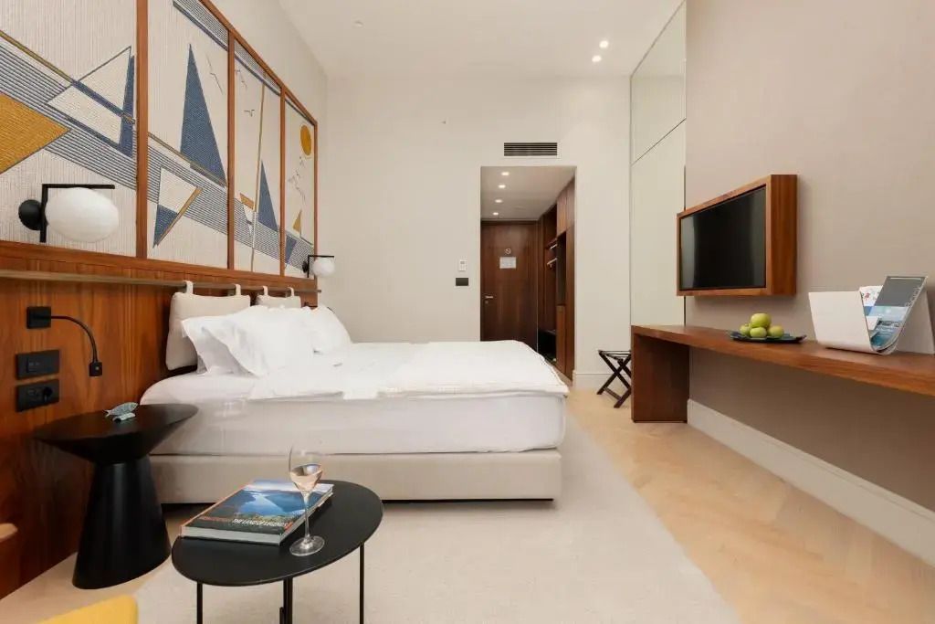 Komfortables Superior Zimmer mit Tisch und Weißweinglas im ĀNANTI Resort