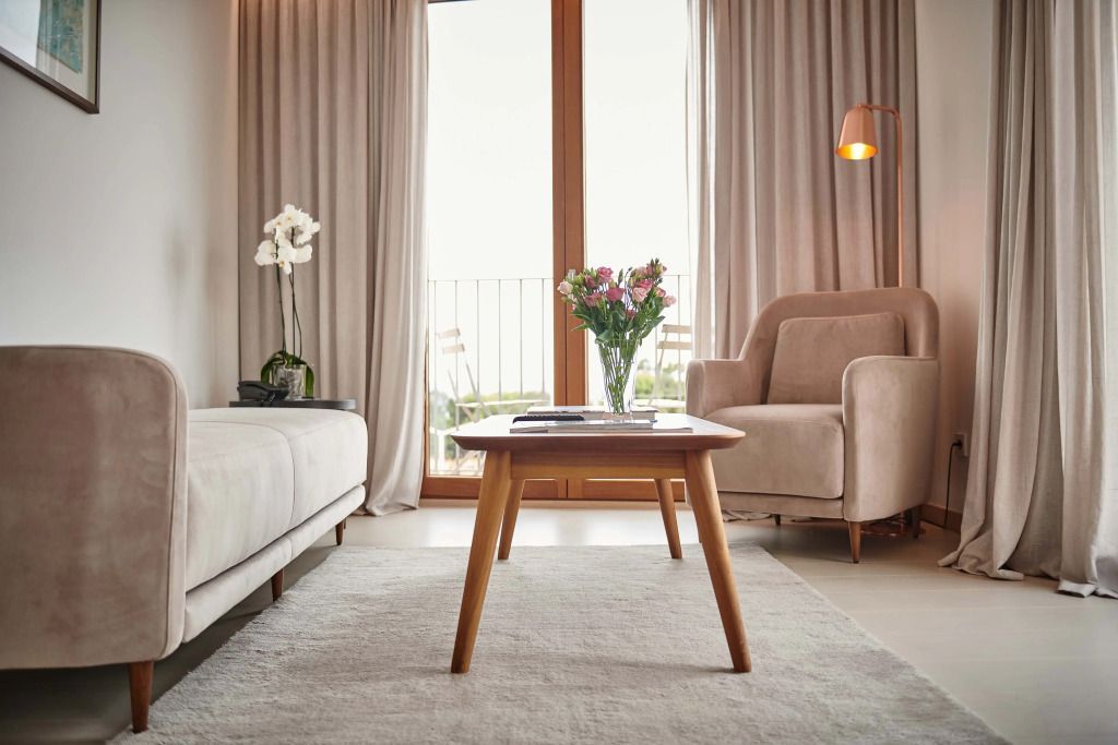 Gemütlicher Wohnbereich mit Sofa, Sessel und Holztisch