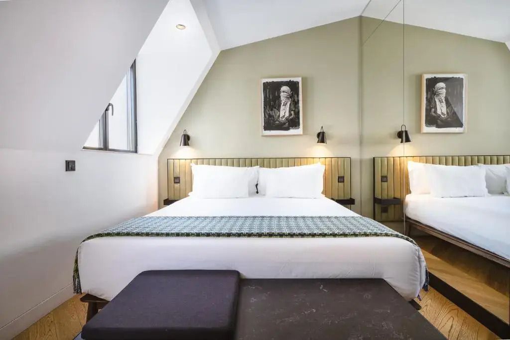 Gemütliches Doppelzimmer mit Dachfenster und stilvollem Wandbild