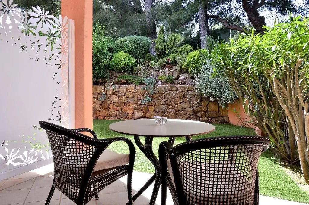 Balkon mit Sitzgelegenheit und Blick auf gepflegten Garten