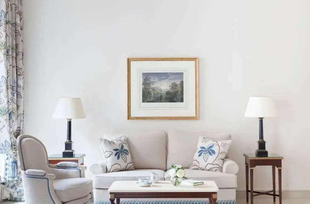 Eleganter Sitzbereich mit Sofa und Kunstwerk im Prestige Doppelzimmer
