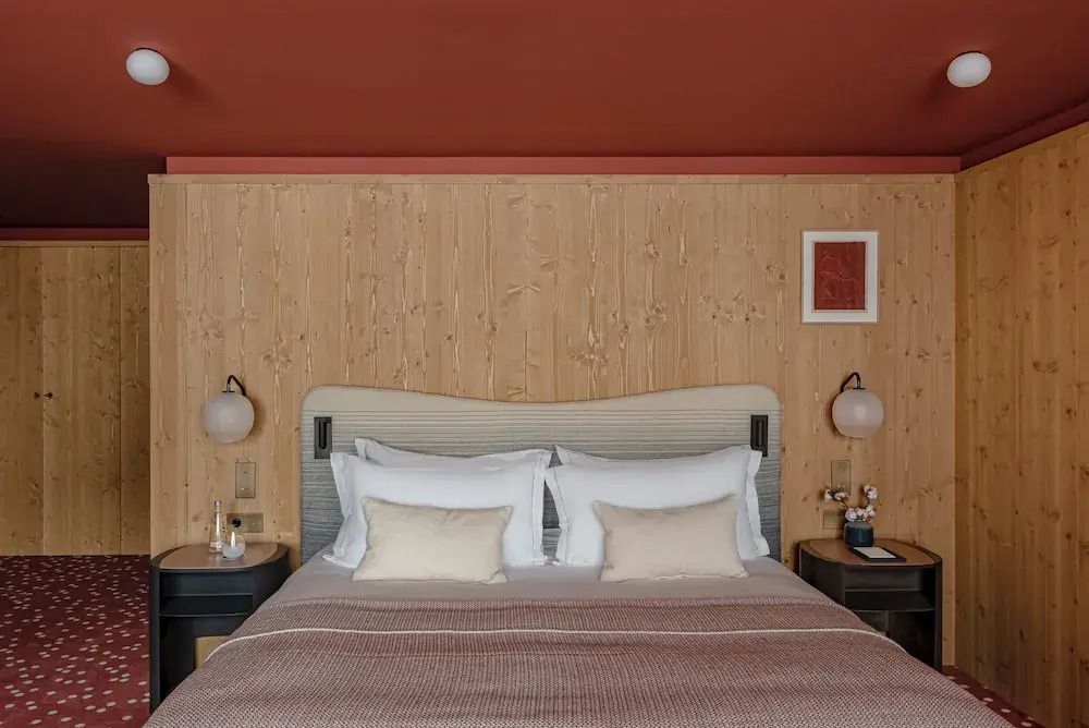 Elegantes Bett mit Holzvertäfelung und stilvoller Dekoration