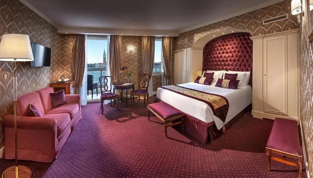 Gemütliches Zimmer mit Doppelbett und stilvollen Möbeln im Londra Palace Venezia