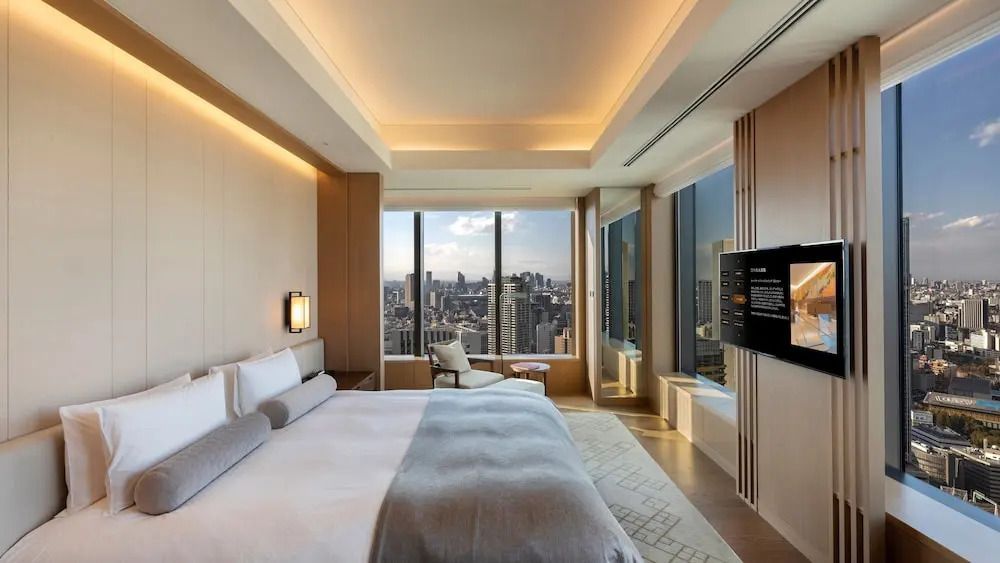 Luxuriöses Schlafzimmer mit großen Fenstern und Stadtblick