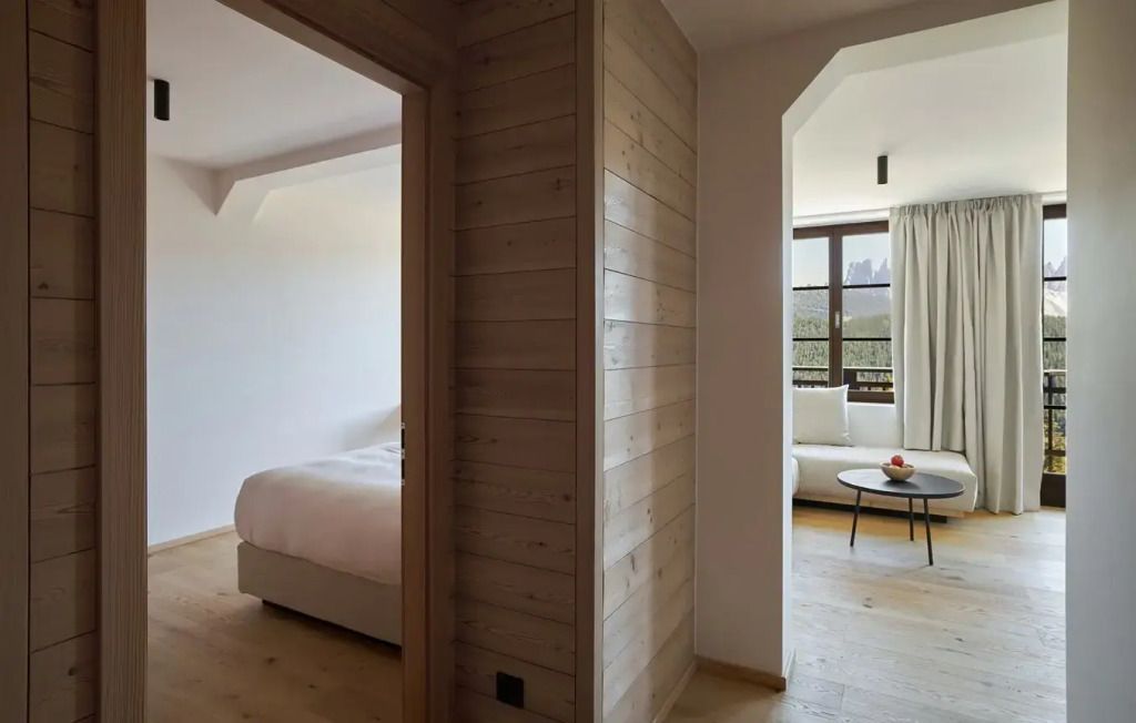 Fluransicht im Zimmer mit Holzvertäfelung und Durchgang zum Wohnbereich
