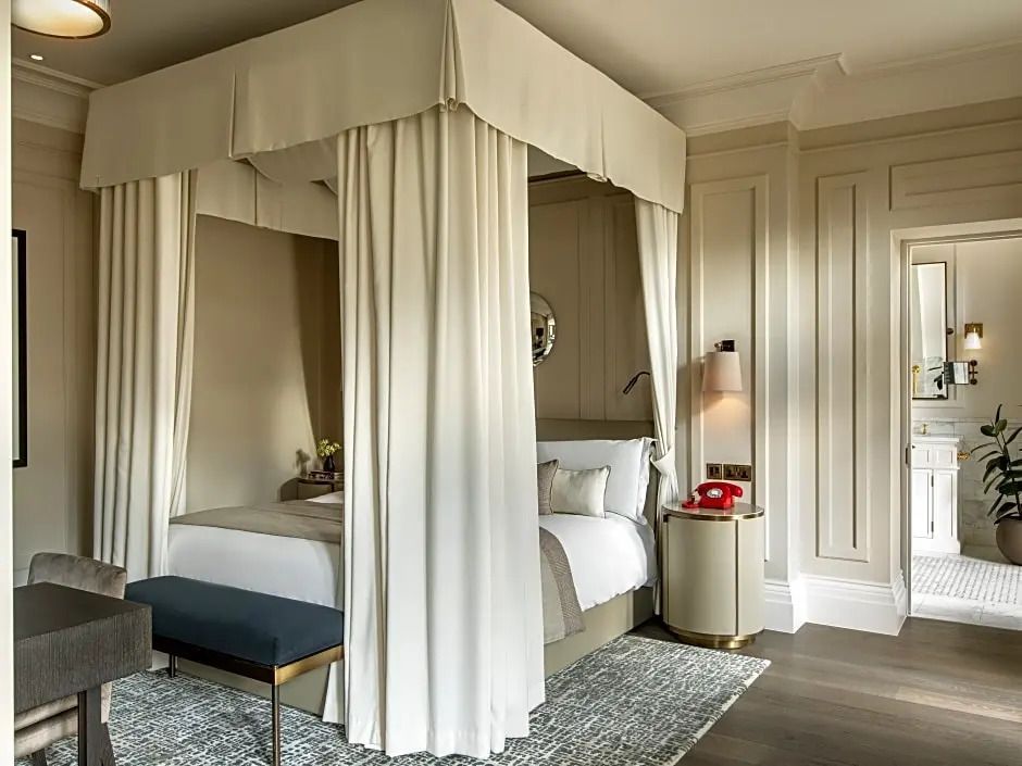 Elegantes Zimmer mit Himmelbett und klassischem Dekor