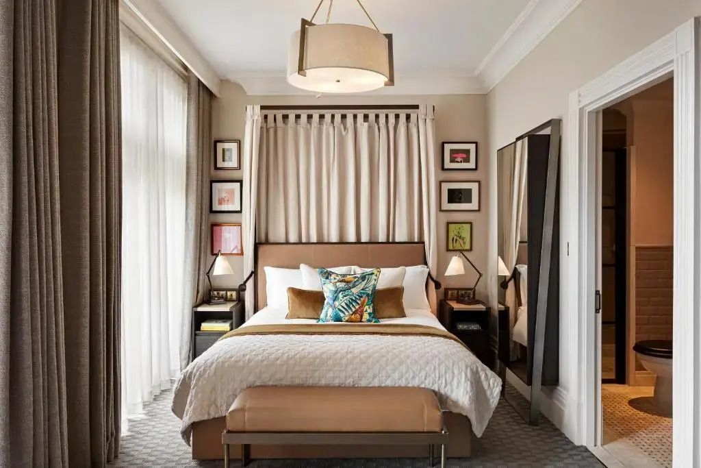 Elegantes Premiumzimmer mit Kingsize-Bett, stilvollen Kunstwerken und moderner Beleuchtung