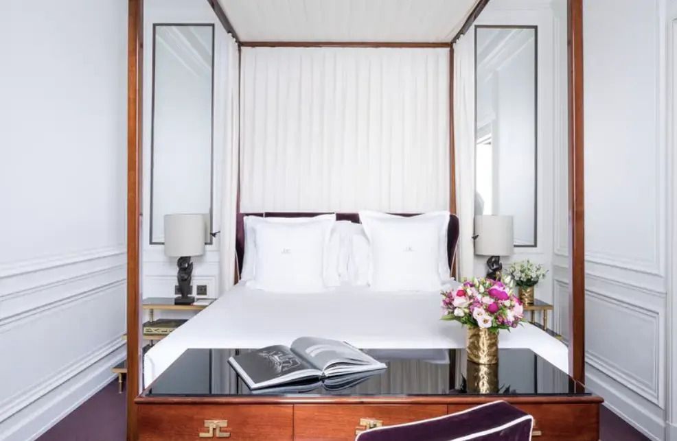 Elegantes Deluxe Doppelzimmer mit Himmelbett und Lesematerialien, romantisch dekoriert