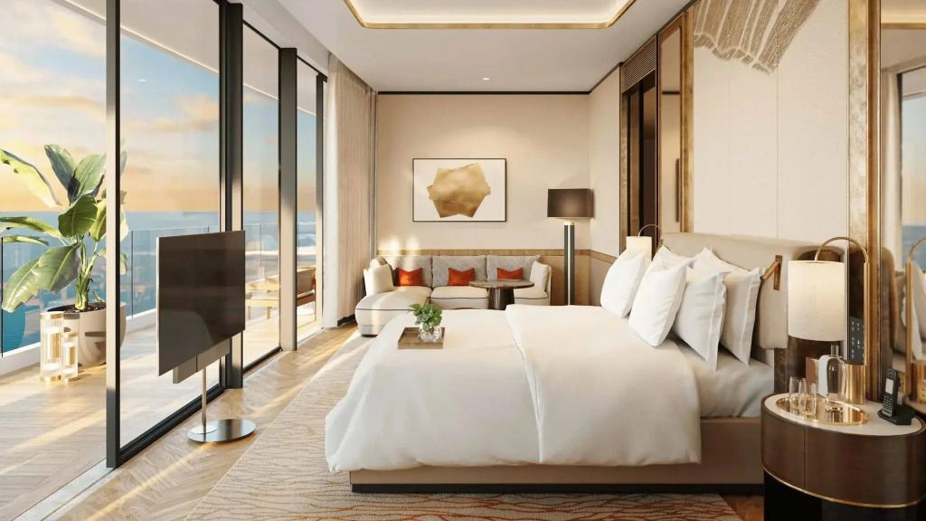 Suite mit Doppelbett und Zugang zu einem Balkon mit Meerblick.