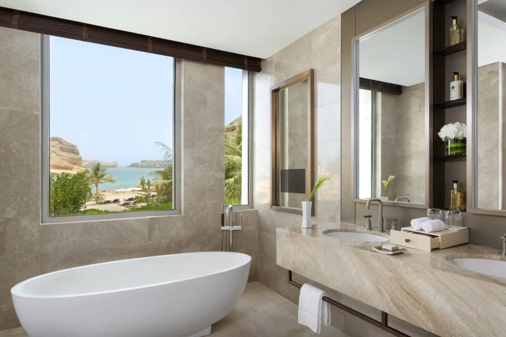 Luxuriöses Badezimmer mit freistehender Badewanne und Meerblick.