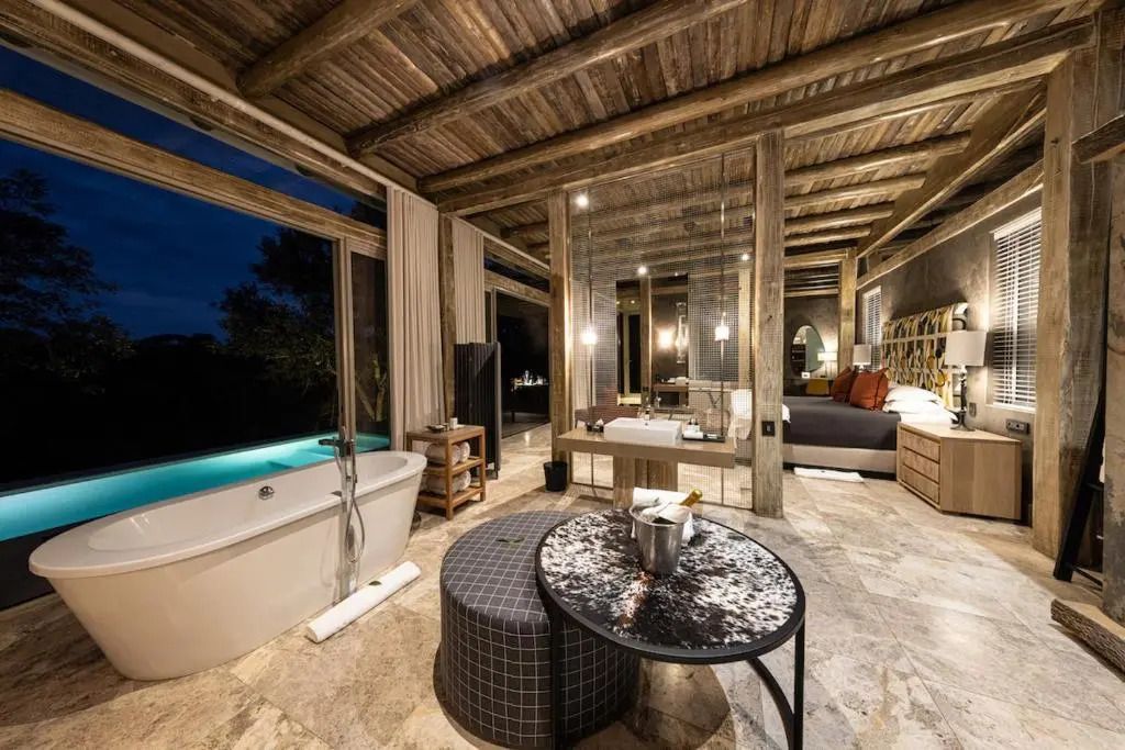 Elegante Villa bei Nacht mit beleuchteter Einrichtung und Aussicht auf Pool