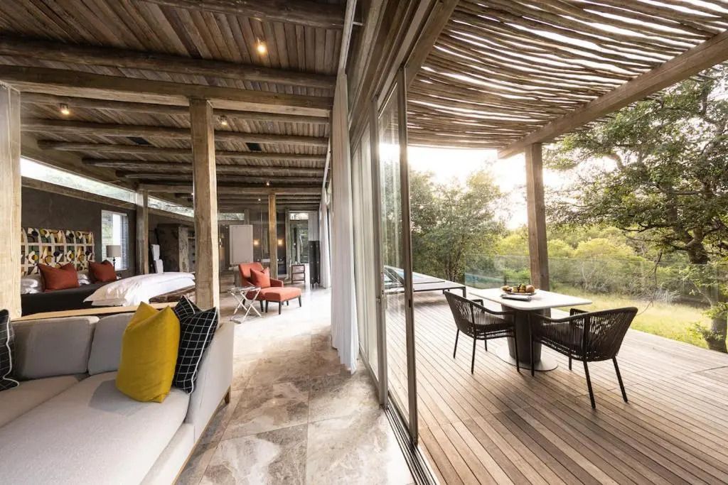 Offener Wohnbereich mit modernen Möbeln und Zugang zur Terrasse mit Essbereich