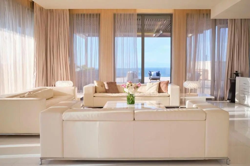 Lichtdurchflutetes Wohnzimmer mit bequemen Sofas und Meerblick