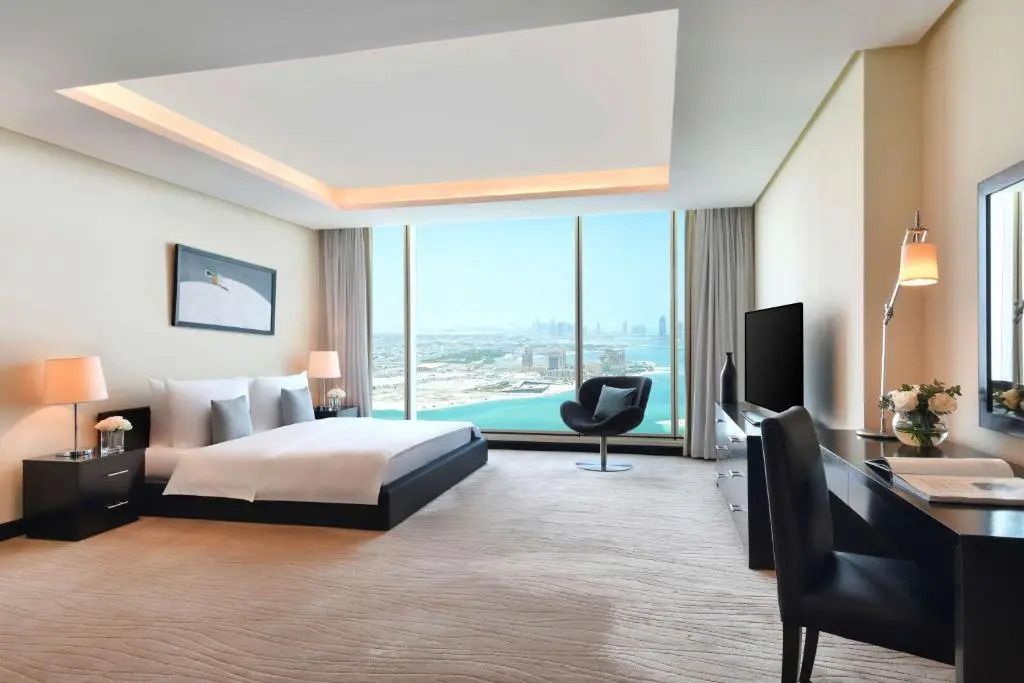 Luxuriöses Schlafzimmer mit Panoramafenster und Blick auf Doha Skyline und das Meer