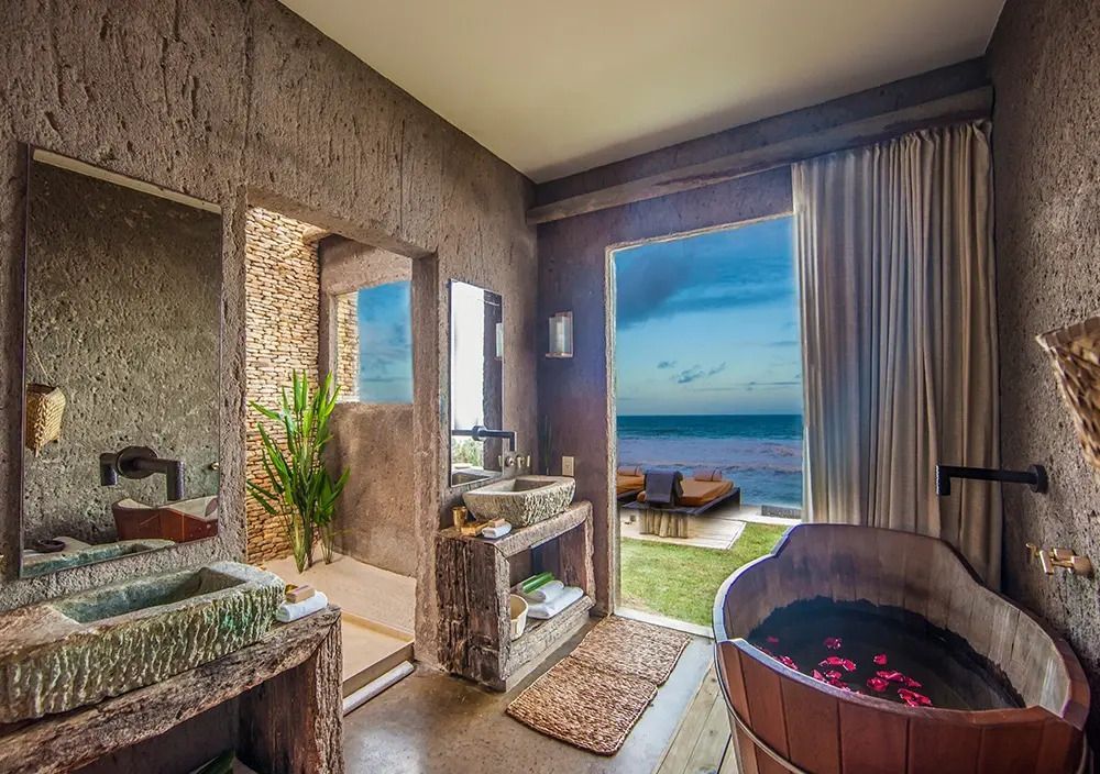 Luxuriöses Badezimmer mit freistehender Badewanne und Meerblick im Kenoa Resort