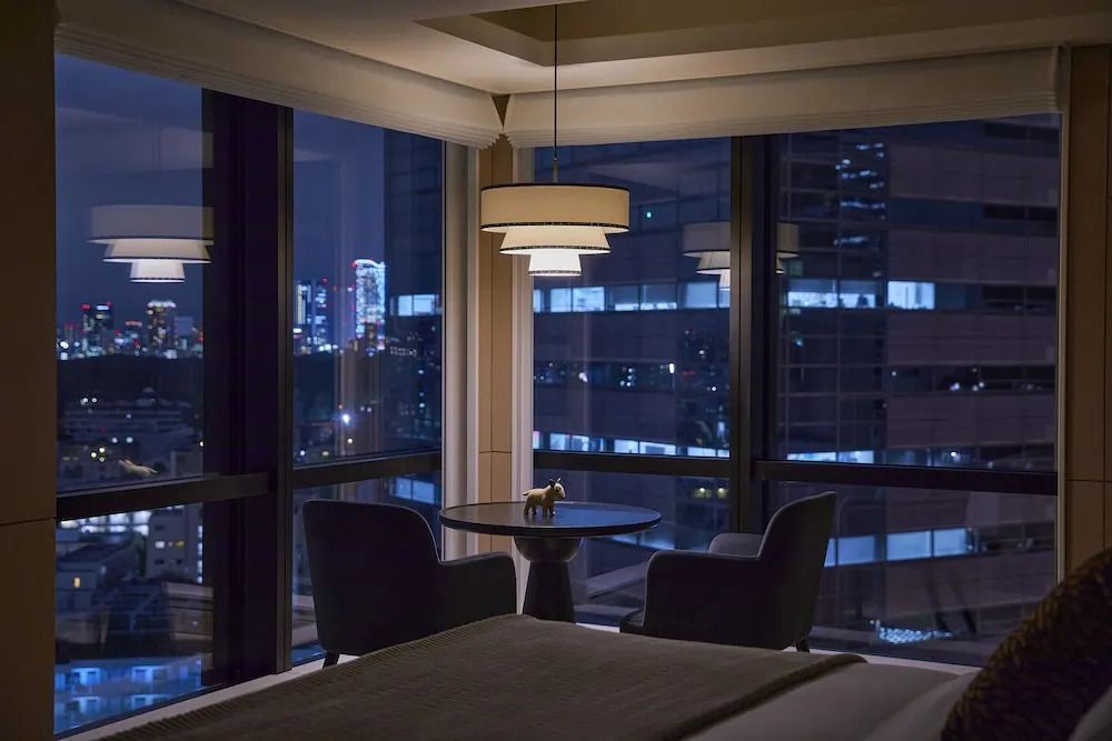 Hochgelegene Suite mit Panoramafenster und nächtlichem Stadtblick