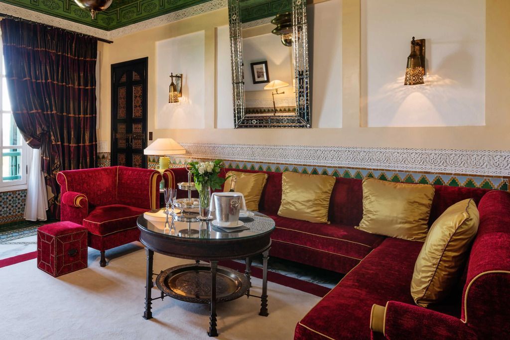 Luxuriöses Wohnzimmer mit rotem Samtsofa und Designertisch.