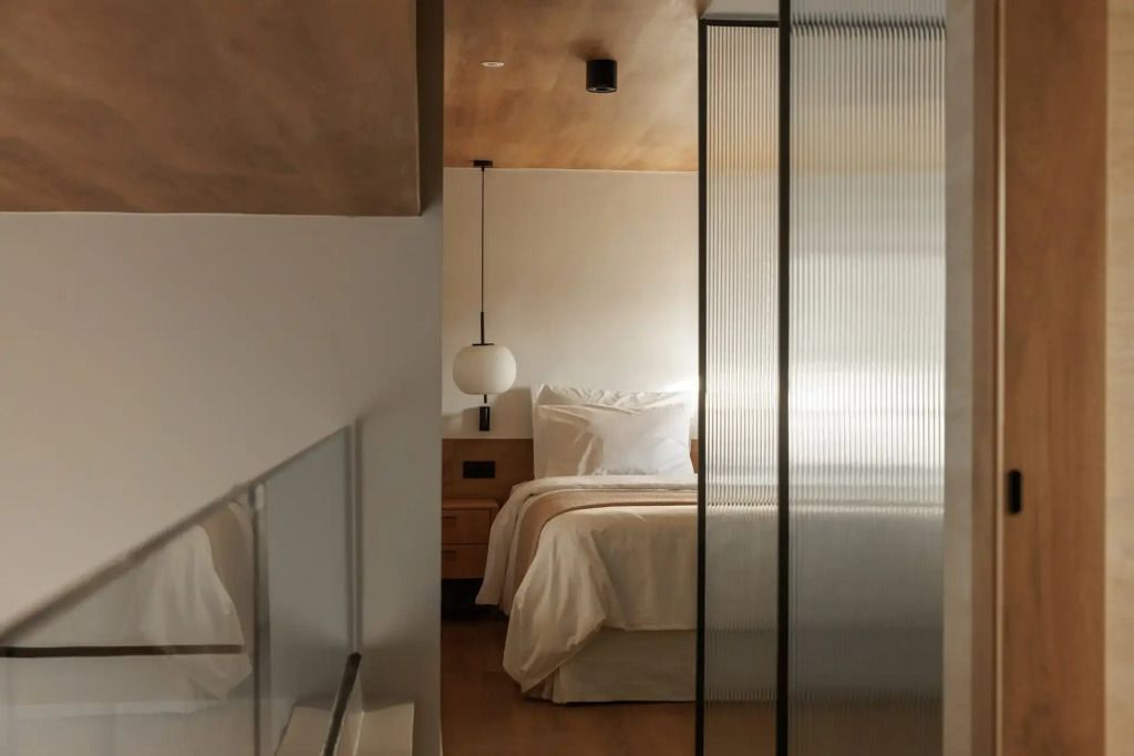 Modernes Schlafzimmer mit gemütlichem Bett und minimalistischer Beleuchtung