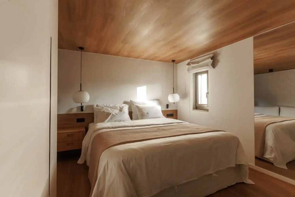 Geräumiges Schlafzimmer mit Doppelbett und Holzverkleidung